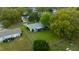 Aerial view showcasing a home with a large, fenced backyard, surrounded by mature trees in a quiet neighborhood at 6385 Sw 61St Ct, Ocala, FL 34474