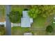 Aerial view of a well-kept home with a gray roof, surrounded by green lawns and mature trees at 6385 Sw 61St Ct, Ocala, FL 34474