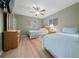 Bright bedroom featuring twin beds, ceiling fan and hardwood floors at 6385 Sw 61St Ct, Ocala, FL 34474