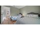 Inviting bedroom with twin beds, wood floors and bedside lamps at 6385 Sw 61St Ct, Ocala, FL 34474