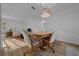 Bright dining room features a wooden table, cushioned chairs, and modern hanging light at 6385 Sw 61St Ct, Ocala, FL 34474