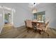Well-lit dining room features a wooden table, cushioned chairs and modern hanging light fixture at 6385 Sw 61St Ct, Ocala, FL 34474