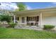 Inviting front porch with rocking chairs and a decorative planter, enhancing the curb appeal of this single-story home at 6385 Sw 61St Ct, Ocala, FL 34474