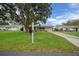 Well-manicured front yard with a charming single-story home, featuring a cozy front porch and attached garage at 6385 Sw 61St Ct, Ocala, FL 34474