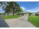 Well-manicured front yard and a long driveway leading up to a charming single-story home on a sunny day at 6385 Sw 61St Ct, Ocala, FL 34474