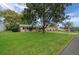 Expansive front yard frames this single-story home, complemented by mature trees and neat landscaping at 6385 Sw 61St Ct, Ocala, FL 34474
