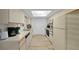 Kitchen with white cabinets, appliances, and a skylight offering natural light at 6385 Sw 61St Ct, Ocala, FL 34474