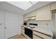 The kitchen features white cabinets, appliances, and a skylight that offers natural light at 6385 Sw 61St Ct, Ocala, FL 34474