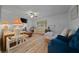 Inviting living room featuring hardwood floors, ceiling fan and comfortable seating at 6385 Sw 61St Ct, Ocala, FL 34474
