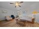Open concept living room with hardwood floors, ceiling fan, and beach themed art at 6385 Sw 61St Ct, Ocala, FL 34474