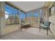 Sunroom with large windows, neutral decor, and outdoor views for relaxing or entertaining at 6385 Sw 61St Ct, Ocala, FL 34474