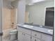 Bathroom featuring a shower-tub combo, toilet, and a sink with vanity mirror at 6767 Sw 114Th Street Rd, Ocala, FL 34476