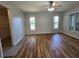 Large primary bedroom with wood floors, large windows, natural light, and a walk-in closet at 6767 Sw 114Th Street Rd, Ocala, FL 34476