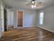 Bright bedroom with wood floors, fan, neutral walls, walk-in closet, and natural light at 6767 Sw 114Th Street Rd, Ocala, FL 34476