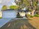 Charming single-story home with attached garage and a beautifully landscaped front yard at 6767 Sw 114Th Street Rd, Ocala, FL 34476