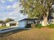 Lovely single-story home featuring an attached garage, mature trees, and a pristine yard at 6767 Sw 114Th Street Rd, Ocala, FL 34476