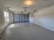 Spacious two-car garage with automatic door opener and side window at 6767 Sw 114Th Street Rd, Ocala, FL 34476