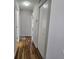 Hallway features hardwood flooring and natural lighting with a closet at 6767 Sw 114Th Street Rd, Ocala, FL 34476