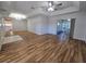 Bright and airy living room with laminate flooring, tray ceiling, and sliding doors to sunroom at 6767 Sw 114Th Street Rd, Ocala, FL 34476