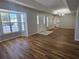 Spacious living room featuring wood floors, tray ceiling, and a bright bay window at 6767 Sw 114Th Street Rd, Ocala, FL 34476