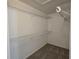 Walk-in closet featuring custom wire shelving and carpeted flooring at 6767 Sw 114Th Street Rd, Ocala, FL 34476