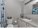Cozy bathroom featuring a single sink, a patterned countertop, and shark-themed shower curtain at 736 Ne 26 Ter, Ocala, FL 34470