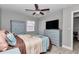 Cozy bedroom with ceiling fan, wood-look floors, a queen bed, and neutral-toned walls at 736 Ne 26 Ter, Ocala, FL 34470