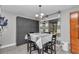 Bright dining area with modern light fixture and striped curtains at 736 Ne 26 Ter, Ocala, FL 34470