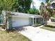 Charming single-story home with attached garage and well-manicured landscaping and a classic, neutral color palette at 736 Ne 26 Ter, Ocala, FL 34470