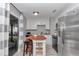 Bright kitchen with white cabinets, stainless steel appliances and sliding glass doors to the backyard at 736 Ne 26 Ter, Ocala, FL 34470