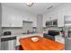 Bright kitchen with stainless steel appliances and classic white cabinetry at 736 Ne 26 Ter, Ocala, FL 34470