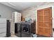 Functional laundry room with modern washer and dryer, cabinet, and an ornate wooden door at 736 Ne 26 Ter, Ocala, FL 34470