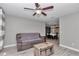 Neutral living room with wood-look floors and a view of the dining room and an open doorway at 736 Ne 26 Ter, Ocala, FL 34470