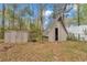View of two outdoor sheds on a wooded lot, providing storage for your lawn and gardening equipment at 736 Ne 26 Ter, Ocala, FL 34470