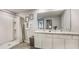 Bathroom with double sinks and a shower-tub combination with decorative shower curtain at 8652 Sw 44Th Ter, Ocala, FL 34476