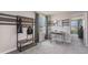 A well-lit bedroom featuring a neutral color scheme, study desk, and modern decor at 8652 Sw 44Th Ter, Ocala, FL 34476