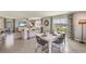 Open-concept dining area with modern furniture, stylish decor, and views of the lake at 8652 Sw 44Th Ter, Ocala, FL 34476