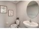A modern half bathroom with a sleek sink, toilet, and stylish decor at 8652 Sw 44Th Ter, Ocala, FL 34476