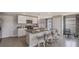 A well-lit kitchen featuring gray cabinets and countertops, complete with bar stool seating at the island at 8652 Sw 44Th Ter, Ocala, FL 34476