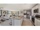 Open kitchen and living area featuring stainless steel appliances and eat in kitchen island at 8652 Sw 44Th Ter, Ocala, FL 34476