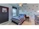 Stylish bedroom featuring a star-themed accent wall, a plush bed, and a window with pleasant natural light at 8658 Sw 44Th Ter, Ocala, FL 34476