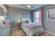 Charming bedroom decorated with pink accents, a cozy bed, and a delightful personalized touch, perfect for a room at 8658 Sw 44Th Ter, Ocala, FL 34476