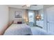 Cozy bedroom with soft grey walls, a plush bed, and a charming decorative cabinet with natural light at 8658 Sw 44Th Ter, Ocala, FL 34476