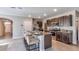 Kitchen with granite counters, stainless appliances, dark cabinets, and bar stool seating at 8658 Sw 44Th Ter, Ocala, FL 34476