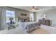 Bedroom with large windows, carpet, and dresser with decorative lamps and mirror at 8658 Sw 44Th Ter, Ocala, FL 34476