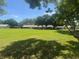 Expansive backyard with green grass and view of the backs of neighboring homes at 9380 Sw 84Th Ter # E, Ocala, FL 34481