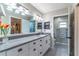 Bright bathroom with double vanity, modern fixtures, and view into the custom closet at 9380 Sw 84Th Ter # E, Ocala, FL 34481