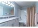 Updated bathroom with vanity, stylish mirror, and shower with patterned curtain at 9380 Sw 84Th Ter # E, Ocala, FL 34481