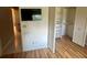 Bedroom view featuring wood floors, a mounted TV, and a closet with ample storage at 9380 Sw 84Th Ter # E, Ocala, FL 34481