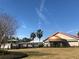 Community center with copper-roofed architectural details, outdoor patios, and landscaped lawn under a blue sky at 9380 Sw 84Th Ter # E, Ocala, FL 34481